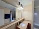 Bright bathroom showcasing granite countertop, vanity, and large framed mirror at 13427 Blue Heron Dr # 2-1401, Orlando, FL 32821