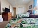 Spacious bedroom with twin beds, tropical bedding, and a dresser with a TV at 13427 Blue Heron Dr # 2-1401, Orlando, FL 32821