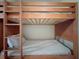 Wooden bunk beds with mattresses and ladder access at 13427 Blue Heron Dr # 2-1401, Orlando, FL 32821