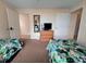 Twin beds featuring colorful tropical animal print bedding in bright bedroom at 13427 Blue Heron Dr # 2-1401, Orlando, FL 32821
