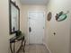 Home entryway featuring tile flooring, front door, and decorative table at 13427 Blue Heron Dr # 2-1401, Orlando, FL 32821