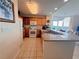 Kitchen with granite counters, oak cabinetry and stainless appliances overlooking dining area at 13427 Blue Heron Dr # 2-1401, Orlando, FL 32821