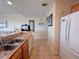 Galley kitchen with tile floors and stainless steel sink at 13427 Blue Heron Dr # 2-1401, Orlando, FL 32821