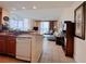 Inviting open-concept living area with a modern kitchen, comfortable seating, and balcony access at 13427 Blue Heron Dr # 2-1401, Orlando, FL 32821