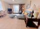 Cozy living room featuring tile flooring, comfortable seating, and access to a private balcony at 13427 Blue Heron Dr # 2-1401, Orlando, FL 32821