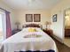 Bright bedroom with two bedside tables, a decorative headboard, and ensuite bathroom access at 13427 Blue Heron Dr # 2-1401, Orlando, FL 32821