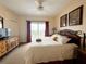 Bedroom with dresser, balcony access and comfortable bedding at 13427 Blue Heron Dr # 2-1401, Orlando, FL 32821