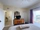 Bedroom with balcony access, dresser, and entry hallway at 13427 Blue Heron Dr # 2-1401, Orlando, FL 32821
