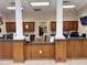 Reception desk with dark wood paneling and granite countertop at 13427 Blue Heron Dr # 2-1401, Orlando, FL 32821