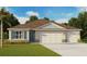 Inviting single-story home featuring stone accents, a three-car garage, manicured lawn, and neutral color palette at 1359 Scarlett Sage Ln, Sanford, FL 32773