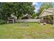 Expansive backyard with shed, fenced perimeter, and lush green lawn at 145 Lakeside Cir, Sanford, FL 32773