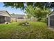 Lush backyard with a storage shed, patio area, and well-kept lawn at 145 Lakeside Cir, Sanford, FL 32773