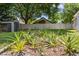 Well-maintained backyard featuring a storage shed and healthy pineapple plants at 145 Lakeside Cir, Sanford, FL 32773