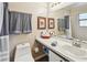 Bathroom featuring a toilet, sink, and a shower tub with a shower curtain at 145 Lakeside Cir, Sanford, FL 32773
