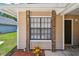 Close up of the home's entrance and front window framed by brick pillars at 145 Lakeside Cir, Sanford, FL 32773