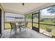 Enclosed patio with outdoor dining set, offering a serene view of the backyard at 145 Lakeside Cir, Sanford, FL 32773