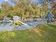 Inviting playground with various play structures, swings, and slides, set on a safe, cushioned surface at 145 Lakeside Cir, Sanford, FL 32773