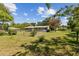 Backyard with a chain-link fence and small trees surrounding the house at 146 Mills Rd, Deland, FL 32724