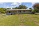 A charming single-story home boasting a spacious backyard enclosed with a chain-link fence at 146 Mills Rd, Deland, FL 32724