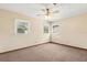 Bedroom featuring carpet, ceiling fan, and three windows providing lots of natural light at 146 Mills Rd, Deland, FL 32724