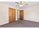 Bedroom with carpeted floors, a ceiling fan, and double door closet at 146 Mills Rd, Deland, FL 32724