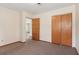 Bedroom featuring neutral paint, carpet, and a closet with sliding doors at 146 Mills Rd, Deland, FL 32724
