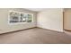 Bedroom featuring neutral walls, carpet flooring, and a large window providing natural light at 146 Mills Rd, Deland, FL 32724