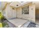 View of a home's entryway, featuring the front door and a side window at 146 Mills Rd, Deland, FL 32724