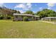 Charming single-story home with a well-manicured lawn and brick facade on a sunny day at 146 Mills Rd, Deland, FL 32724