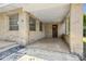 Covered front porch with brick pillars and a dark wooden front door at 146 Mills Rd, Deland, FL 32724