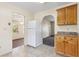 Kitchen featuring tile floors, cabinets, and white refrigerator, opening to other rooms at 146 Mills Rd, Deland, FL 32724