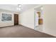 Living room featuring a ceiling fan, tile to carpet transition, and built-in shelves at 146 Mills Rd, Deland, FL 32724