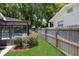 Backyard with fenced in pool area and a lush green lawn, offering a private outdoor oasis at 1639 Choctaw Trl, Maitland, FL 32751