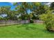 A lush backyard with a well-maintained lawn surrounded by a wooden fence and mature trees at 1639 Choctaw Trl, Maitland, FL 32751