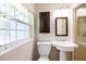 Cozy bathroom with stall shower, pedestal sink, medicine cabinet and window at 1639 Choctaw Trl, Maitland, FL 32751