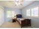Bedroom with carpet, ceiling fan, two shuttered windows and a small bed at 1639 Choctaw Trl, Maitland, FL 32751
