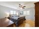 Comfortable bedroom with wood floors, ceiling fan, shutters and blue-themed bedding at 1639 Choctaw Trl, Maitland, FL 32751