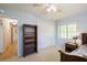 Bedroom with carpet, closet, bookshelf, shuttered window and ceiling fan at 1639 Choctaw Trl, Maitland, FL 32751