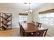 Bright dining room featuring a wooden table and chairs, a modern light fixture, and natural light at 1639 Choctaw Trl, Maitland, FL 32751