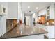 Kitchen with stainless steel appliances, stone countertops, stone tile floors, and white cabinetry at 1639 Choctaw Trl, Maitland, FL 32751