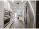 Modern kitchen with stainless steel appliances, stone tile floors, and ample cabinet space at 1639 Choctaw Trl, Maitland, FL 32751