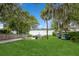 Expansive lawn space with outdoor seating and mature trees, perfect for entertaining or relaxation by the water at 1639 Choctaw Trl, Maitland, FL 32751