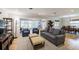 Bright and spacious living room featuring wood floors, comfortable seating, and an open layout connecting to the dining area at 1639 Choctaw Trl, Maitland, FL 32751