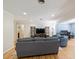 Cozy living room with wood floors, gray sofa, blue armchairs, and natural light at 1639 Choctaw Trl, Maitland, FL 32751