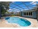 A screened-in pool area with clear blue water and a surrounding brick patio offers a private outdoor retreat at 1639 Choctaw Trl, Maitland, FL 32751