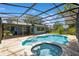 Screened-in pool and spa surrounded by brick patio at 1639 Choctaw Trl, Maitland, FL 32751