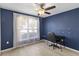 Navy bedroom with a fan and desk at 16603 Corner Lake Dr, Orlando, FL 32820