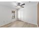 Bright bedroom features a ceiling fan, closet, and a window with blinds offering natural light and a wood-look floor at 16603 Corner Lake Dr, Orlando, FL 32820