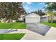 Charming single-story home features a well-manicured lawn and a two-car garage at 16603 Corner Lake Dr, Orlando, FL 32820