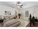 Virtually staged primary bedroom with ceiling fan, neutral color palette, and ensuite bathroom at 16603 Corner Lake Dr, Orlando, FL 32820